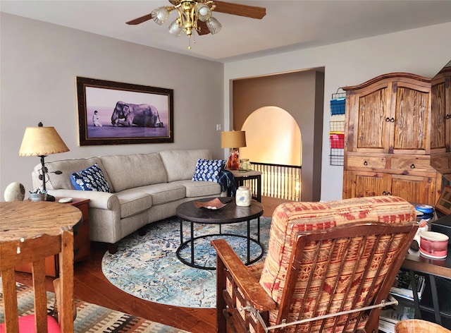 living area with wood finished floors and ceiling fan