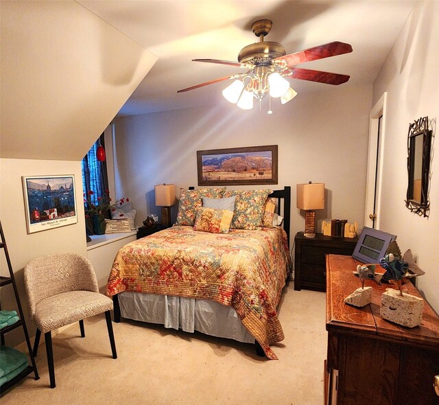 bedroom with a ceiling fan and light carpet