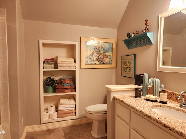 bathroom with toilet, tile patterned floors, vanity, vaulted ceiling, and a shower
