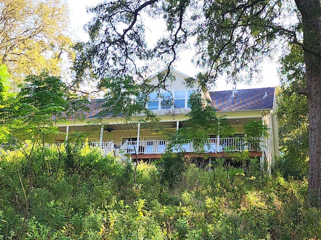 rear view of property with covered porch