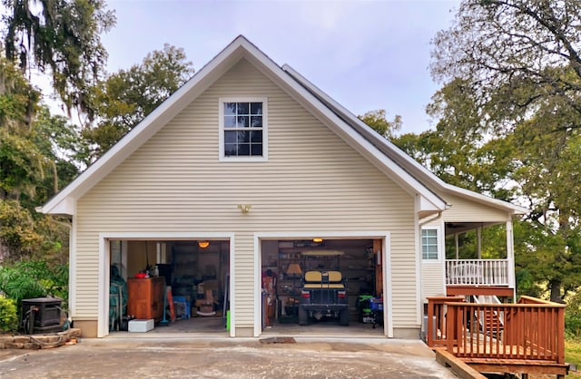 view of side of home with a garage and driveway