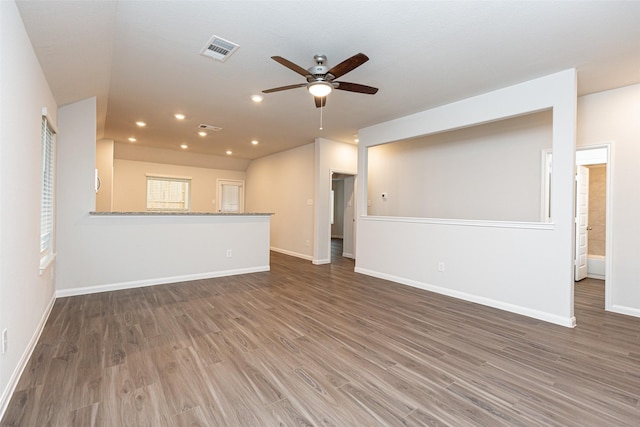 unfurnished living room with ceiling fan and dark hardwood / wood-style flooring