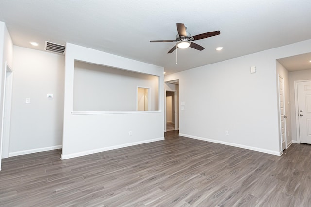 spare room featuring dark hardwood / wood-style floors and ceiling fan