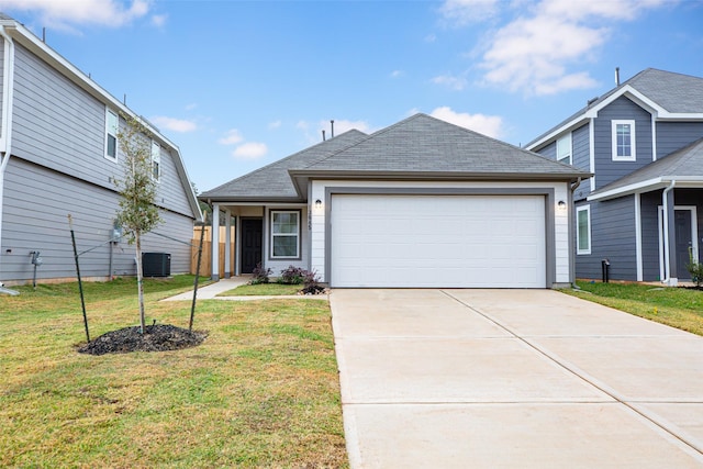 view of front of home with central air condition unit, a front lawn, and a garage