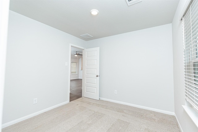 unfurnished bedroom with light colored carpet