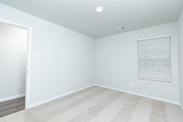 unfurnished room with carpet flooring