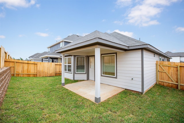 back of property featuring a lawn and a patio area