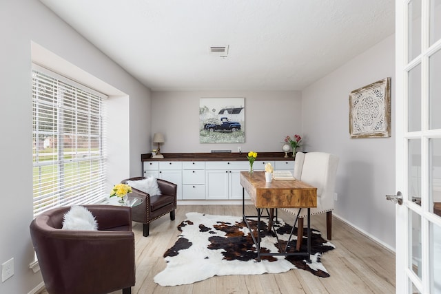 sitting room featuring french doors and light hardwood / wood-style floors