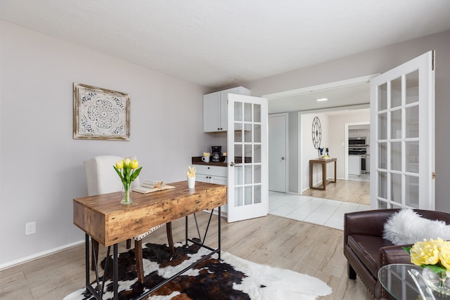 office area featuring light hardwood / wood-style floors and french doors