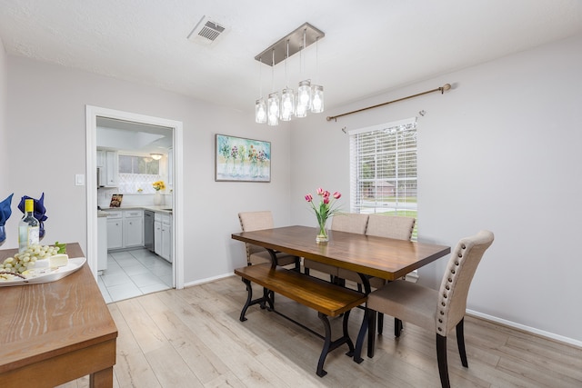 dining space with light hardwood / wood-style flooring