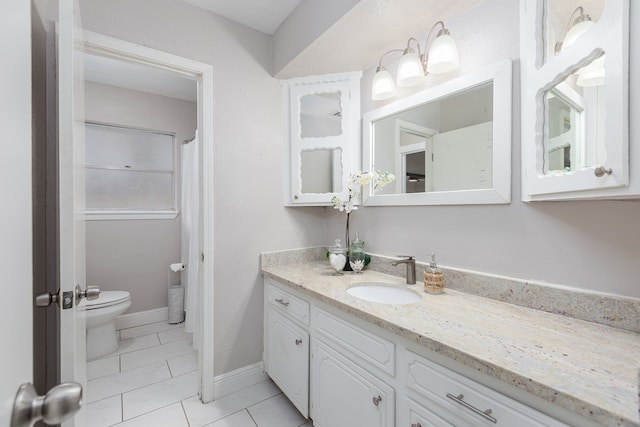 bathroom featuring tile patterned floors, vanity, and toilet