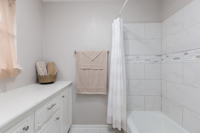 bathroom featuring shower / bath combination with curtain and vanity