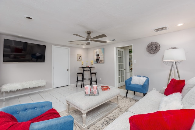 tiled living room with ceiling fan