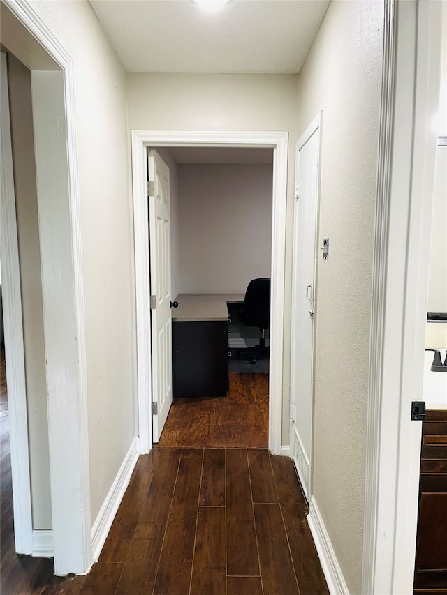 hall with dark wood-type flooring