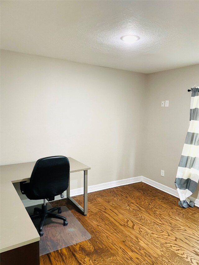 office featuring wood-type flooring and a textured ceiling