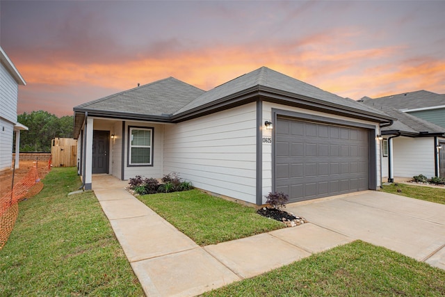 view of front facade with a lawn and a garage