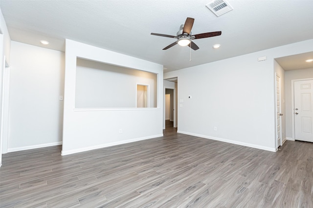 unfurnished room with hardwood / wood-style floors, a textured ceiling, and ceiling fan