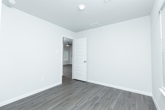 unfurnished room with dark hardwood / wood-style flooring