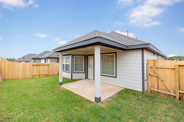 back of property featuring a yard and a patio area