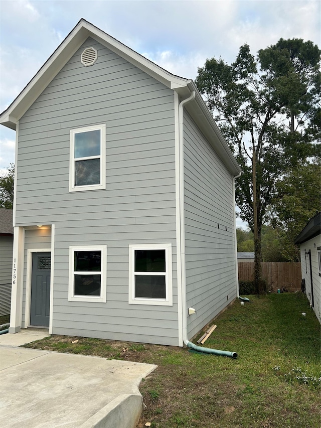 rear view of house with a yard