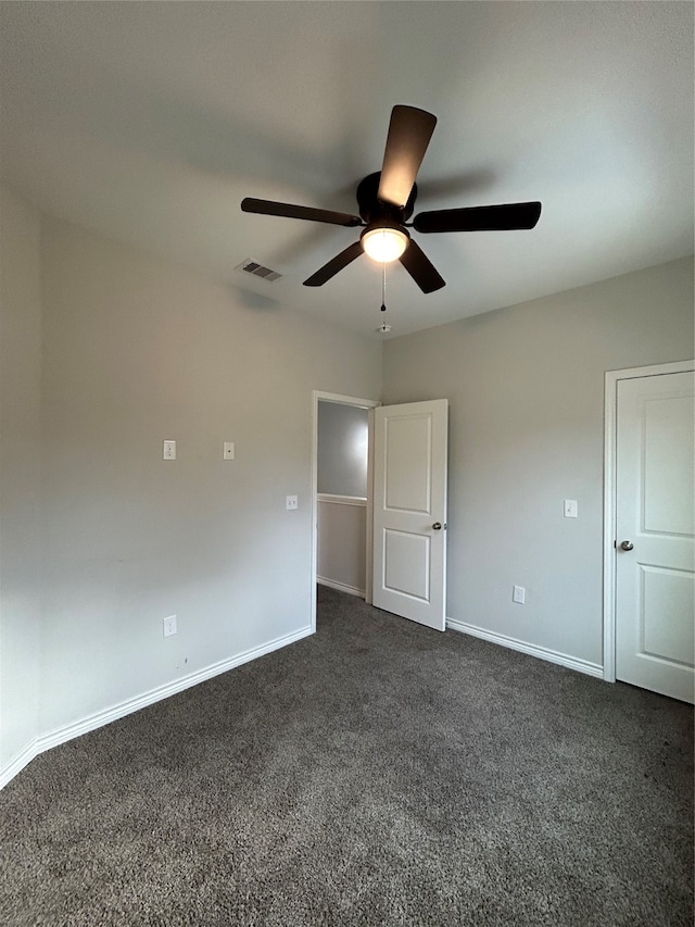 unfurnished bedroom with dark colored carpet and ceiling fan