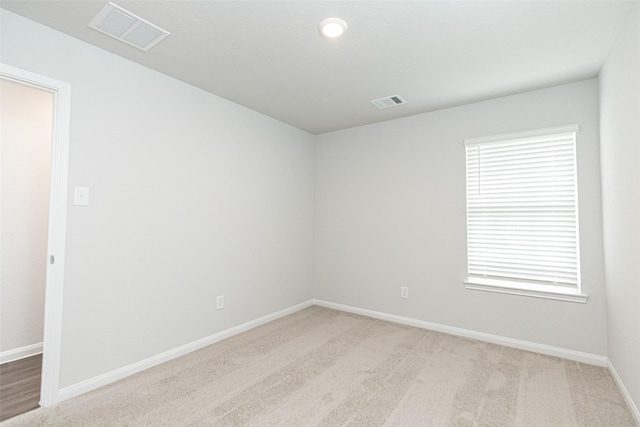 carpeted spare room with a wealth of natural light