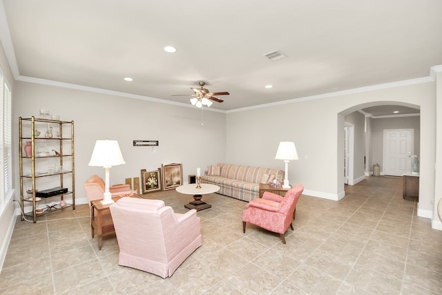 living room with ceiling fan, light tile patterned floors, and crown molding