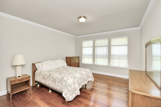 bedroom with multiple windows, dark wood-type flooring, and ornamental molding