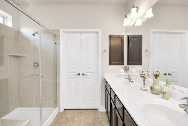 bathroom featuring vanity, tile patterned floors, and walk in shower