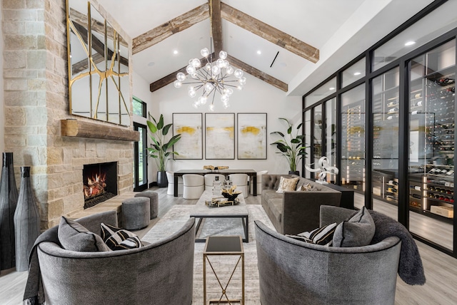 living room featuring high vaulted ceiling, a fireplace, beamed ceiling, a notable chandelier, and light hardwood / wood-style floors