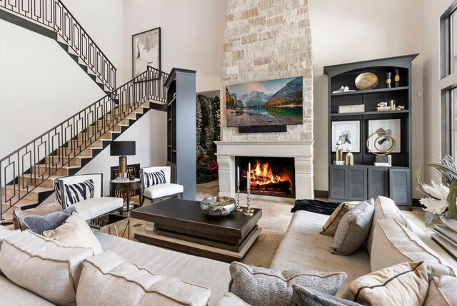 living room featuring built in shelves and a fireplace