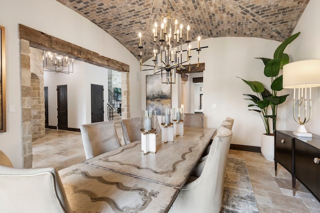 dining room with an inviting chandelier, brick ceiling, and lofted ceiling