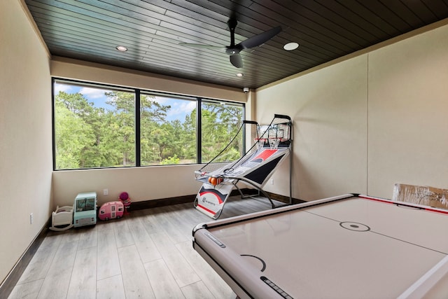 recreation room with ceiling fan, wooden ceiling, and light wood-type flooring