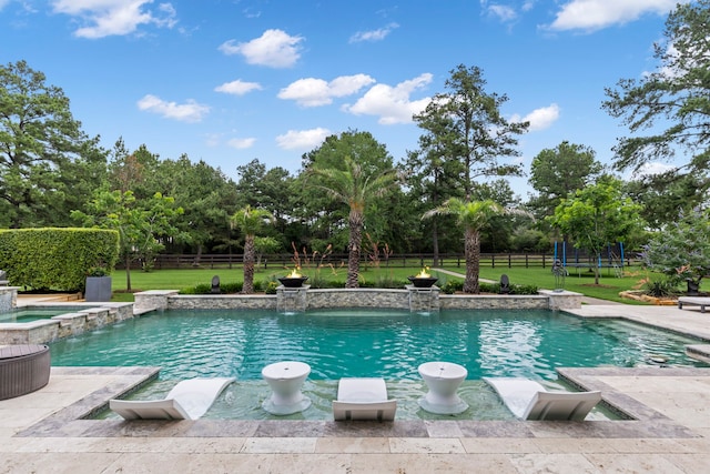 view of swimming pool featuring pool water feature, an in ground hot tub, a trampoline, and a lawn