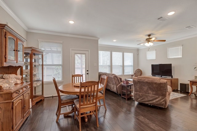 dining room featuring dark hardwood / wood-style flooring, ceiling fan, and crown molding