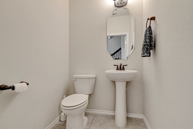 bathroom featuring tile patterned flooring and toilet