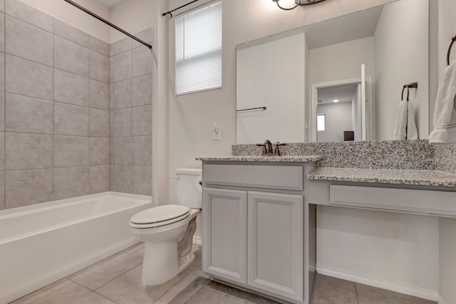 full bathroom featuring toilet, tile patterned flooring, vanity, and tiled shower / bath