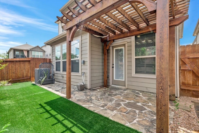 entrance to property featuring a pergola, a patio area, and a lawn