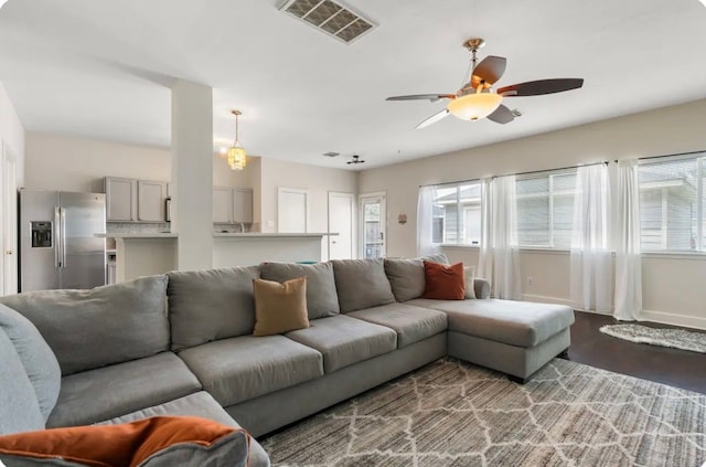 living room with hardwood / wood-style floors and ceiling fan