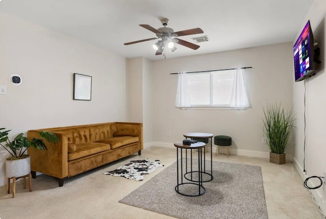 living room with light carpet and ceiling fan