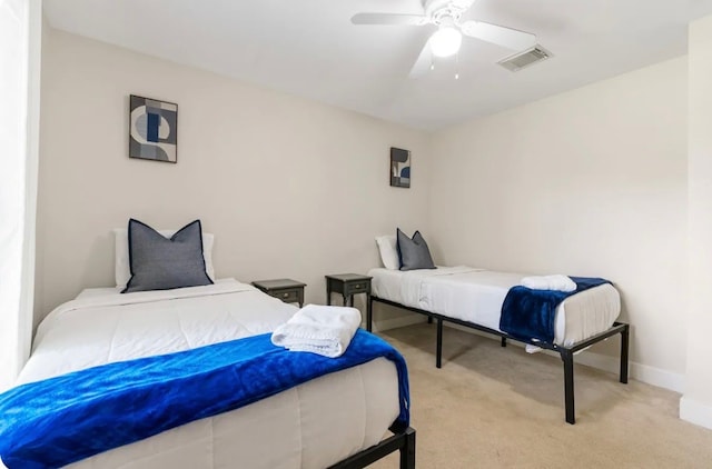 bedroom featuring light colored carpet and ceiling fan