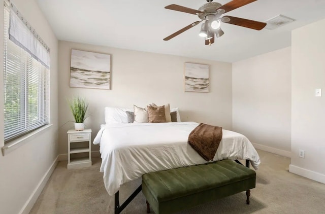 bedroom featuring ceiling fan and light carpet