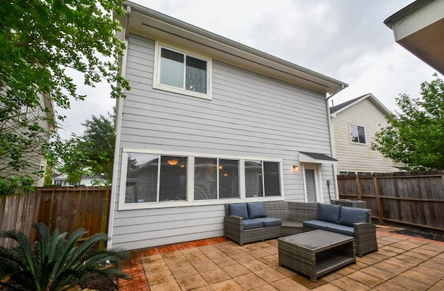 back of house with outdoor lounge area and a patio