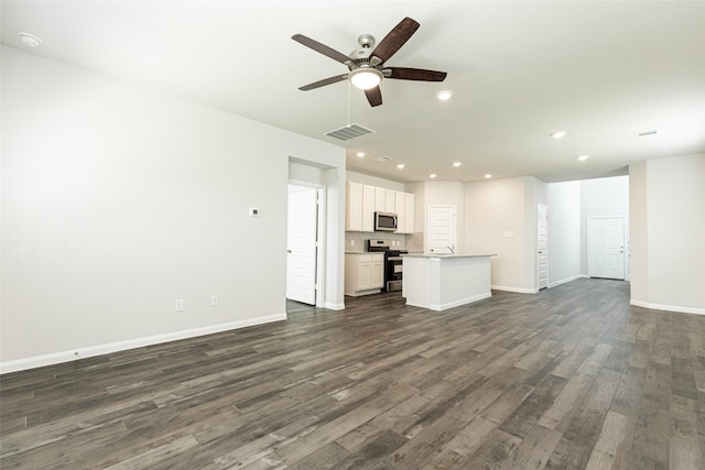 unfurnished living room featuring ceiling fan and dark wood-type flooring