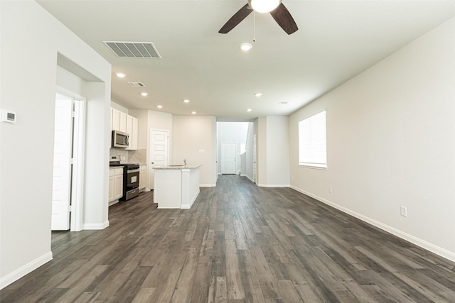 unfurnished living room featuring dark hardwood / wood-style floors and ceiling fan