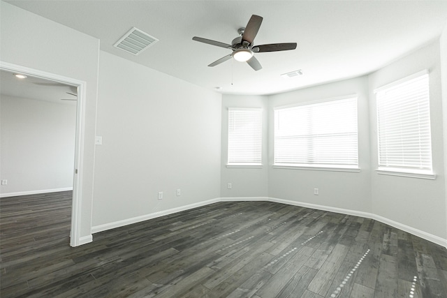 empty room featuring ceiling fan and dark wood-type flooring