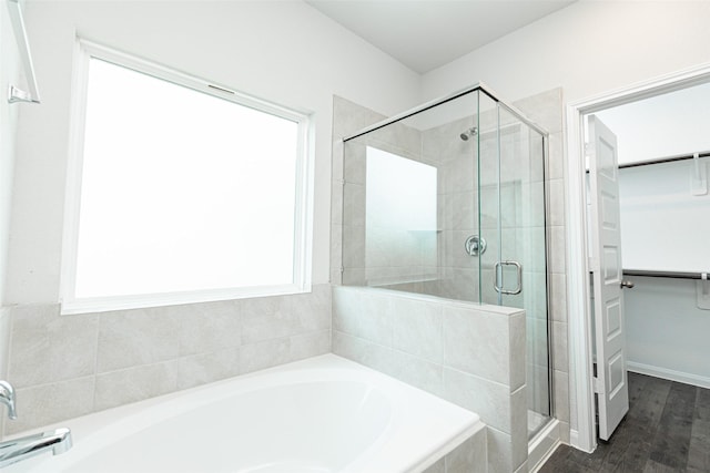 bathroom featuring independent shower and bath and hardwood / wood-style flooring