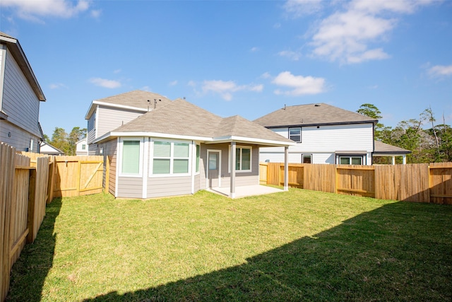 rear view of property featuring a patio area and a lawn