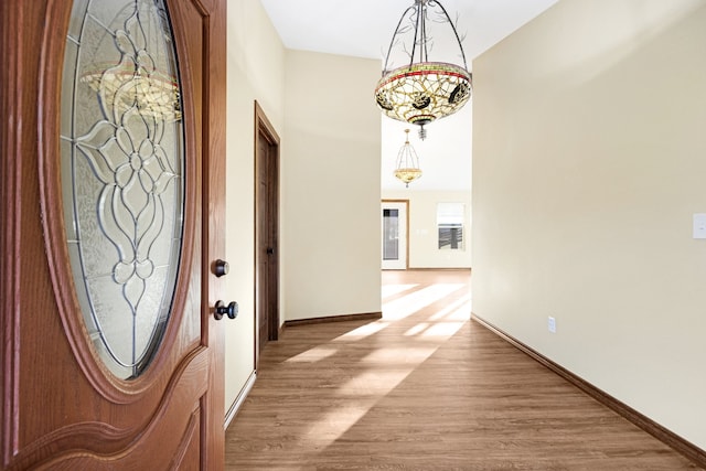 entryway featuring light hardwood / wood-style floors and lofted ceiling