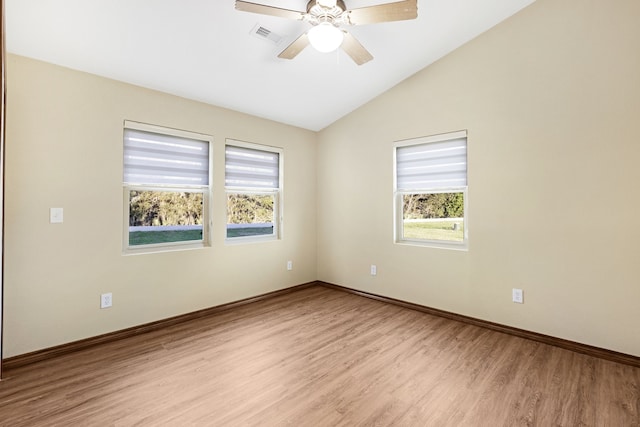 unfurnished room with light hardwood / wood-style floors, vaulted ceiling, plenty of natural light, and ceiling fan